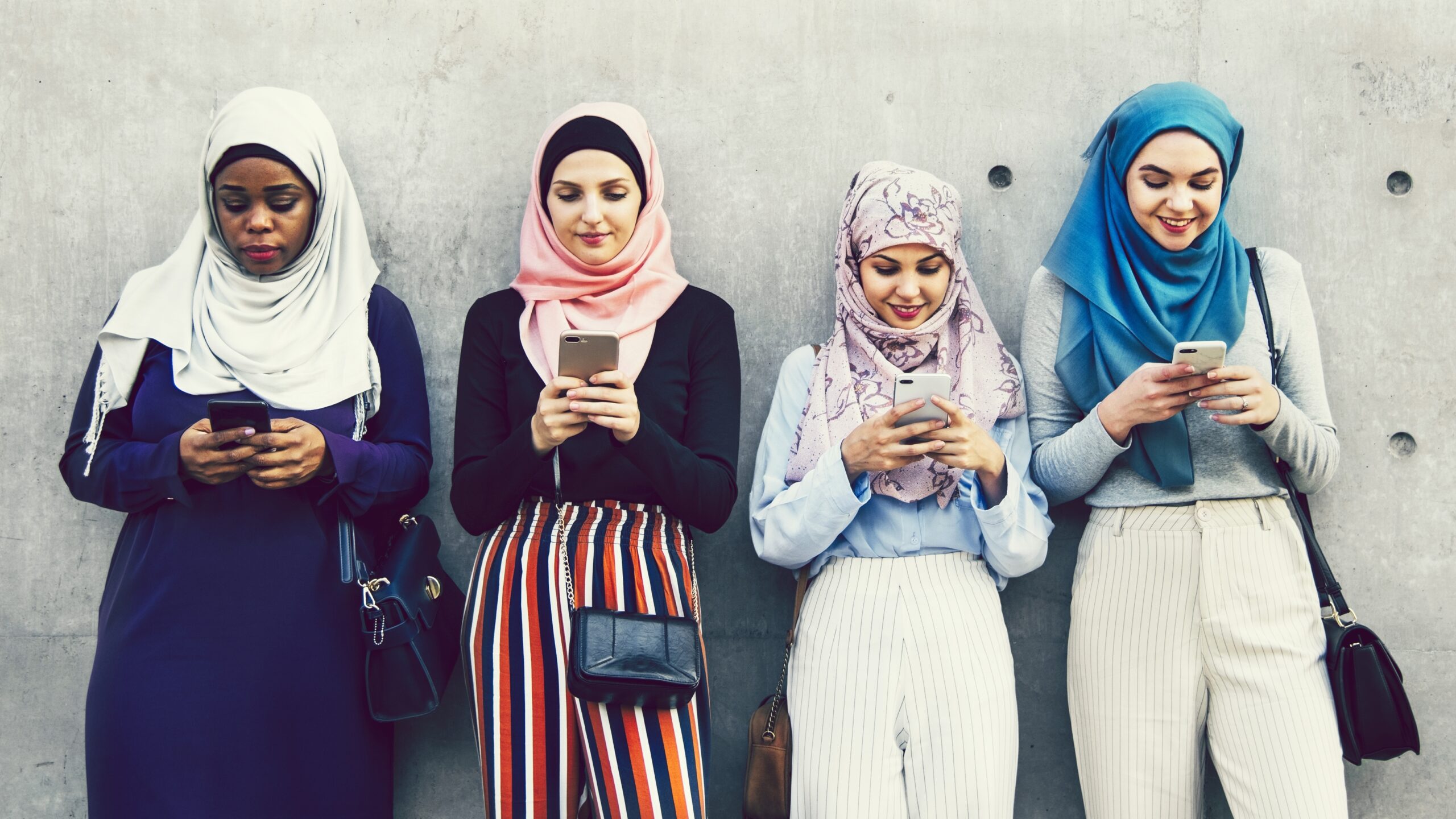 group muslim girls using smartphones 1 scaled